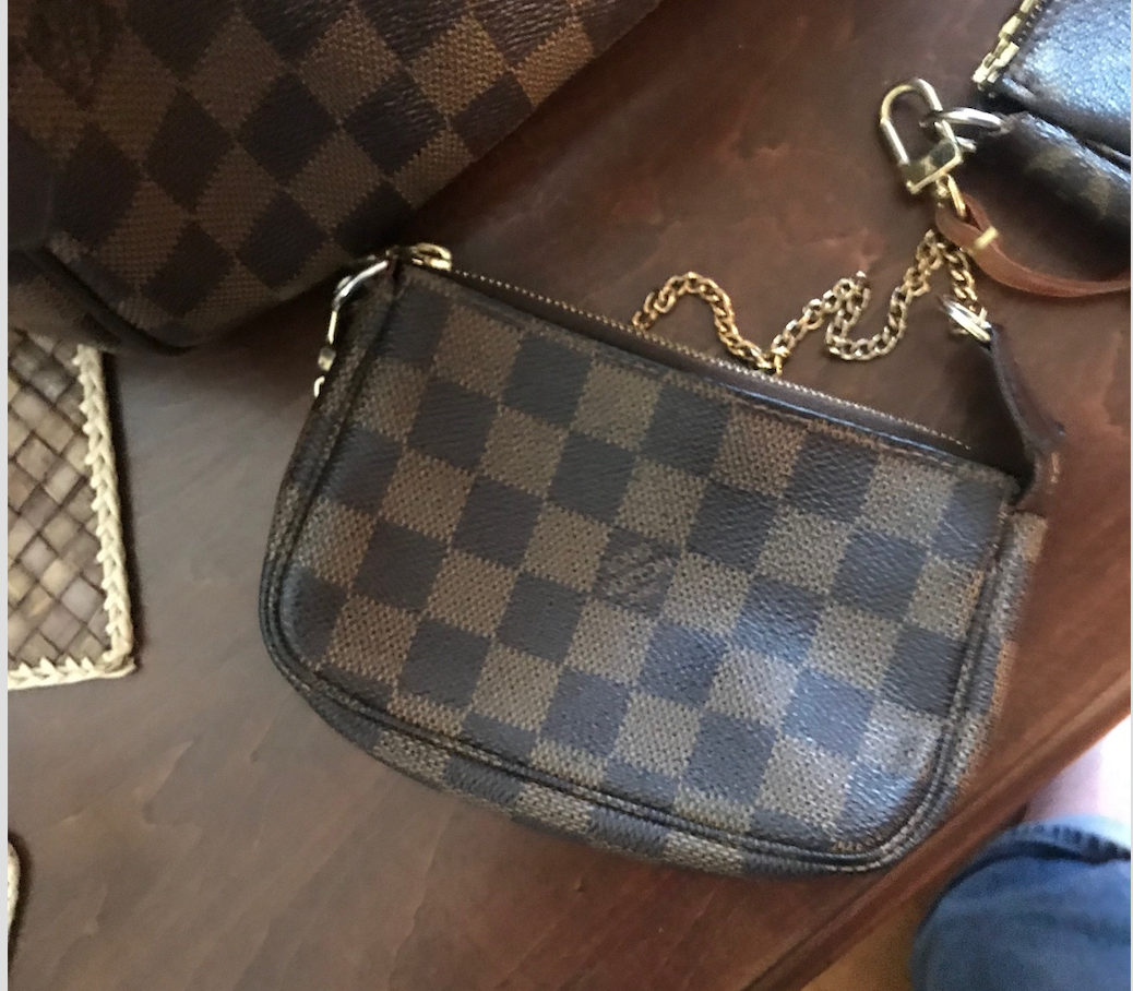 Woman with brown Louis Vuitton checkered bag on September 22, 2018