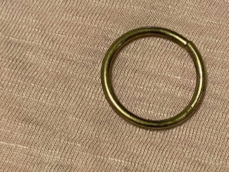 Small brass colored ring from a necklace: 51 ppm Arsenic.