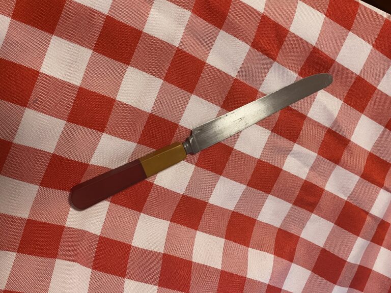 Vintage dinner knife with red and yellow Bakelite handle — 760,500 ppm Lead in the join point