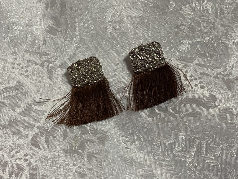 Paparazzi silver colored metal earrings with brown tassels: positive for trace Antimony, Lead & Cadmium.