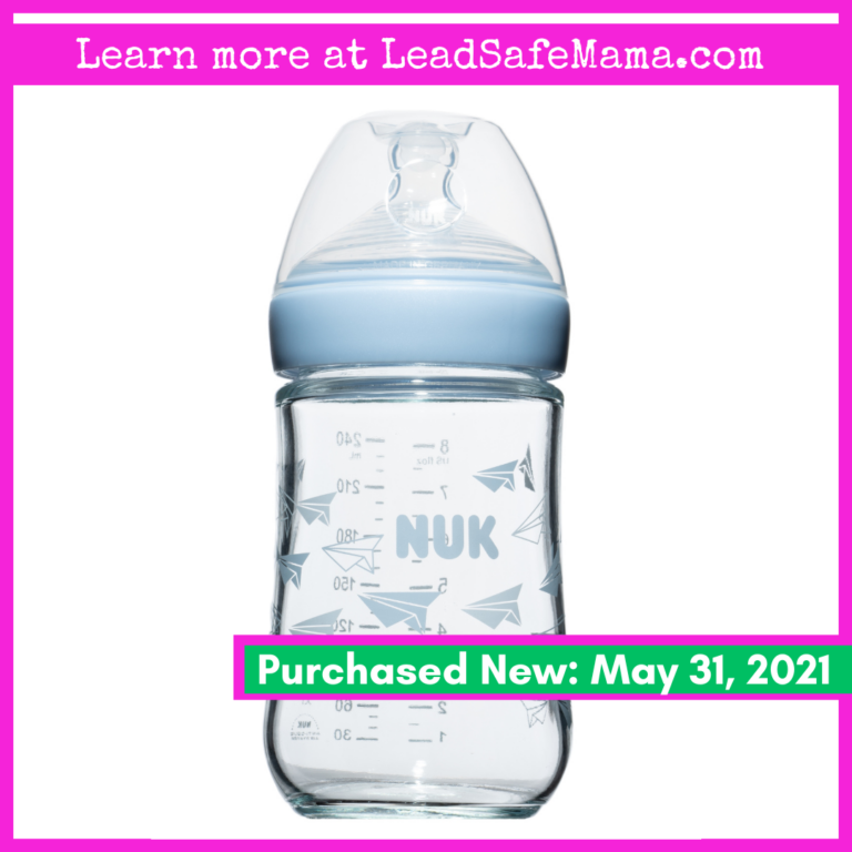 2023 NYC Subway PSA Campaign: NUK Glass Baby Bottle With Blue & White Paper Airplane Design